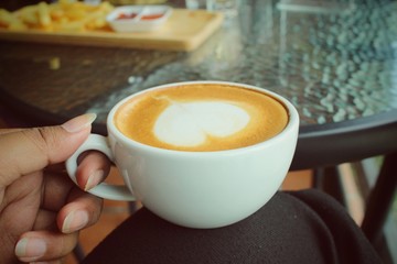 Drinking latte art coffee