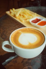 Latte art coffee with french fries