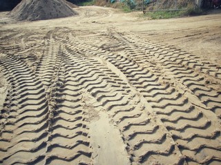 Wheel tracks on the soil.