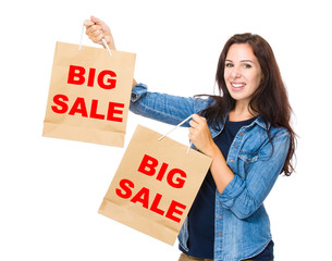 Shopping woman hold with shopping bag and showing big sale