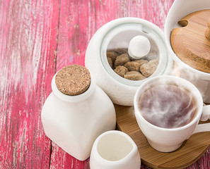 Tea cups with teapot on old wooden table