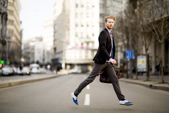 Young Man Walking On The Street