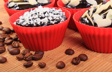 Chocolate muffins with desiccated coconut and almonds, coffee grains