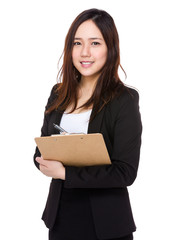 Asian young businesswoman take note on clipboard