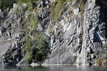 Marble rocks around a mountain lake. Mountain Park Ruskeala, Karelia Republic, Russia