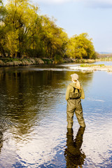woman fishing in the river in spring