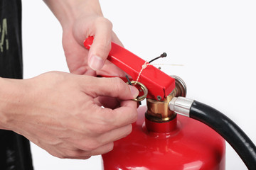 Close- up Fire extinguisher and pulling pin on red tank.