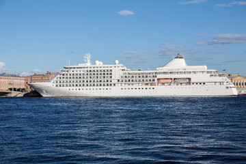 Fototapeta na wymiar Big cruise ship on a mooring on Neva river in Saint-Petersburg, Russia