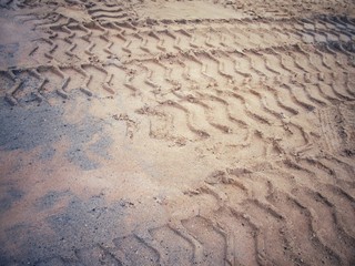 Wheel tracks on the soil.