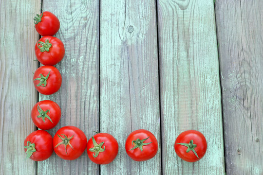 Tomatoes on wooden background. top view