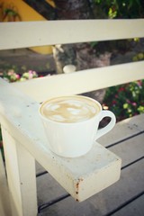Vintage latte art coffee on chair