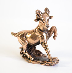 a bronze statuette of a ram