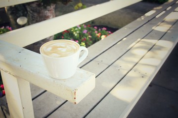 Vintage latte art coffee on chair