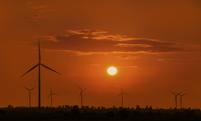 Silhouette wind turbine with sunset