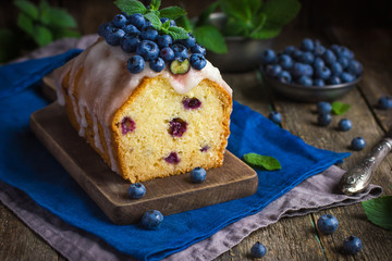 blueberry cake with sugar icing and fresh berries
