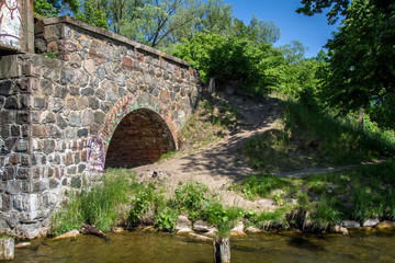 Fototapeta na wymiar Part of the old stone bridge
