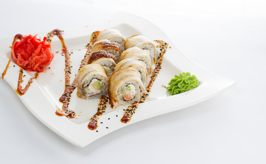 Eel sushi roll with unaghi sauce on a white plate