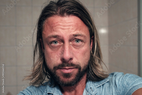Selfie Of Young Man With Long Blonde Hair And Beard In Bathroom