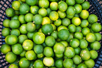 Limes in basket for sell at market.
