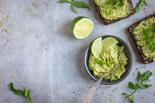  guacamole and rye toasts on rustic  background