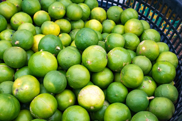 Limes in basket for sell at market.