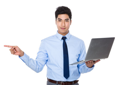 Asian young businessman hold with laptop compuetr and finger poi