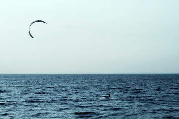 Kite surfer rides on the waves in rever bay 