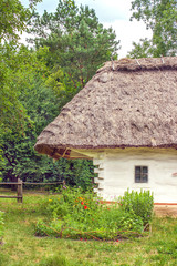 Fototapeta na wymiar landscape clay and wooden hut thatched Ukrainian