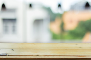 Selected focus empty brown wooden table and Coffee shop blur bac