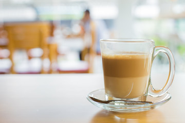 hot latte coffee on wooden table, vintage and retro style