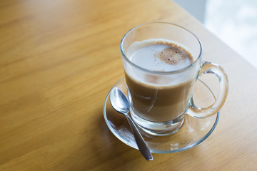 hot latte coffee on wooden table, vintage and retro style
