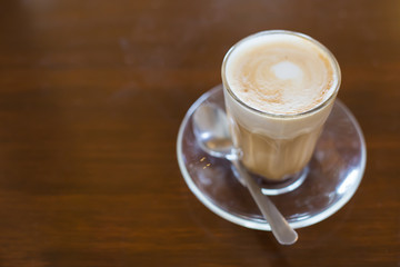 hot latte coffee on wooden table, vintage and retro style
