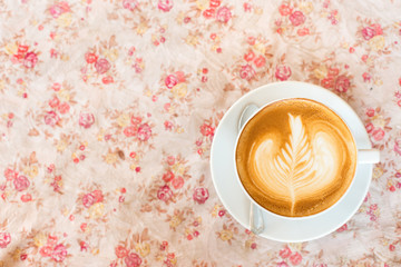 Cup of art latte or cappuccino coffee with retro filter effect a