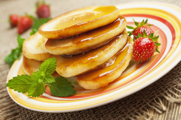 Homemade pancake with honey and strawberry