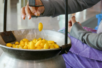  The girl is demonstrating how to produce silk floss yarn from c
