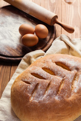Freshly baked traditional bread on rustic wooden background