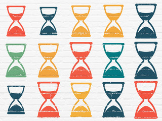 Time concept: Hourglass icons on wall background