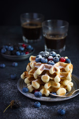 waffles with fresh berries and powdered sugar