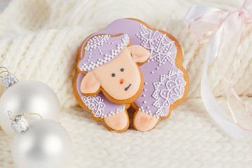 Lavender color gingerbread sheep on white knitted background