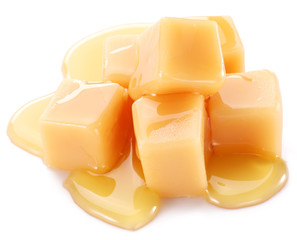 Sweet caramel candies on the white background.