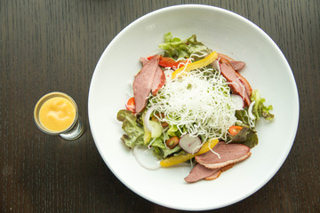 Salad with arugula and duck breast.