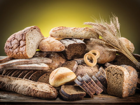 Different types of bread on wooden desk.