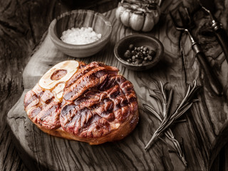 Beef steaks  with spices on a wooden tray.