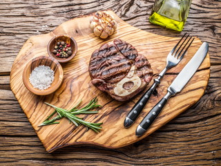 Beef steaks  with spices on a wooden tray.