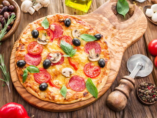 Pizza with mushrooms, salami and tomatoes.