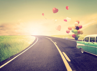 Vintage Car with heart balloon concept of love in summer and wedding honeymoon