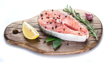 Salmon steak on the cutting board on white background.