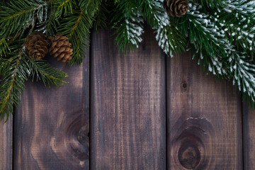 dark wood background with fir branches, top view