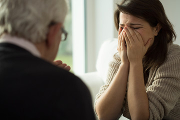 Young woman crying during therapy