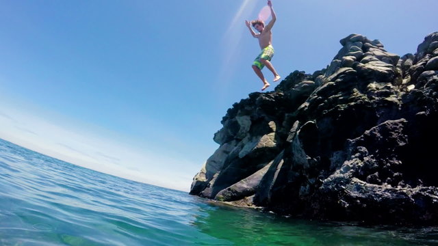 Tropical Cliff Jumping into Blue Ocean.